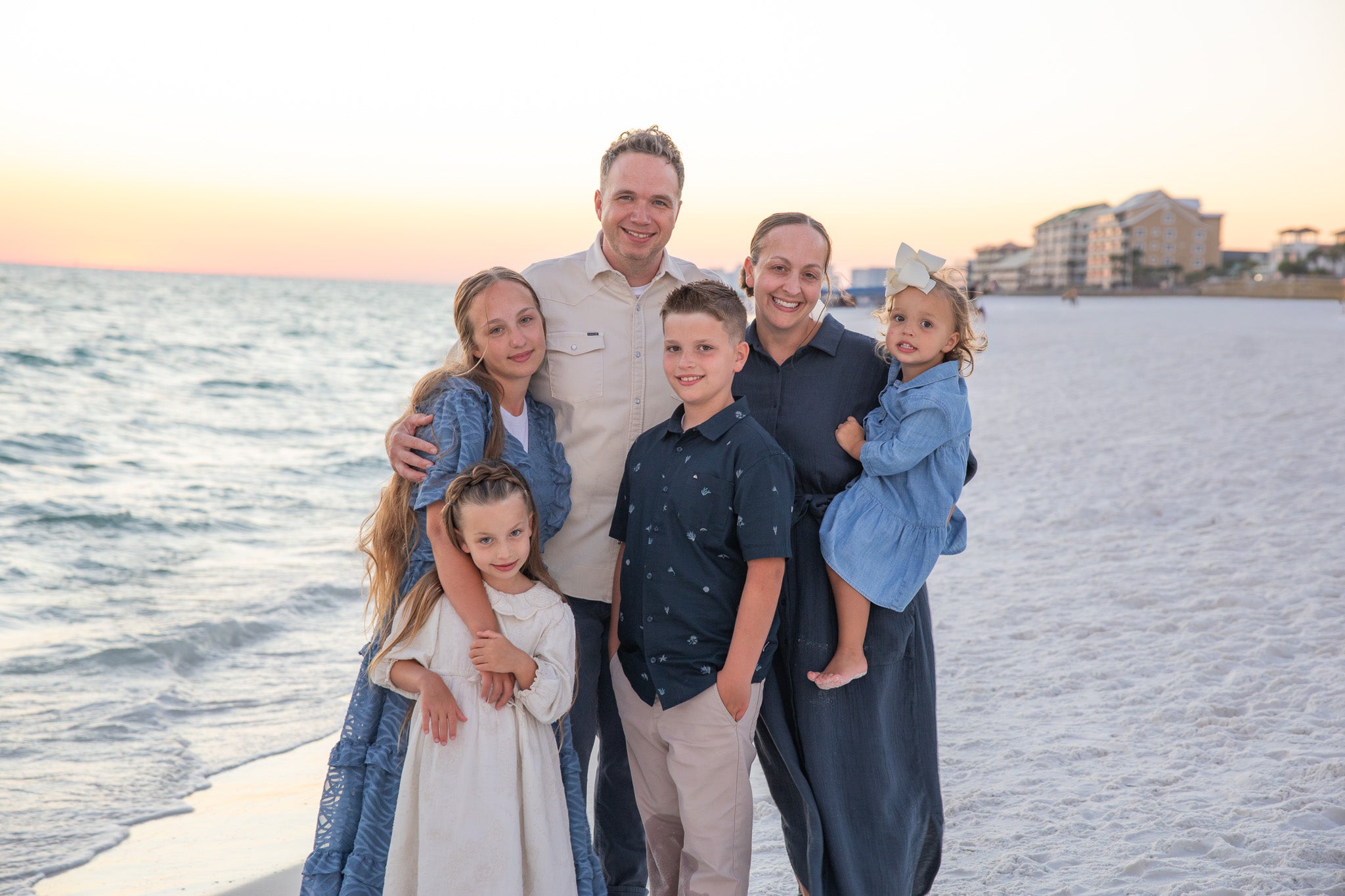 A picture of Austin & Chantelle Rodgers, owners and founders of Nuggles® with their four children.