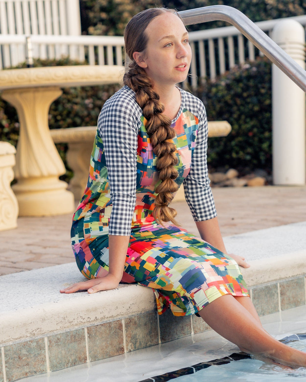 Model wearing Nuggles® Sport Swim Dress in Painted Patchwork