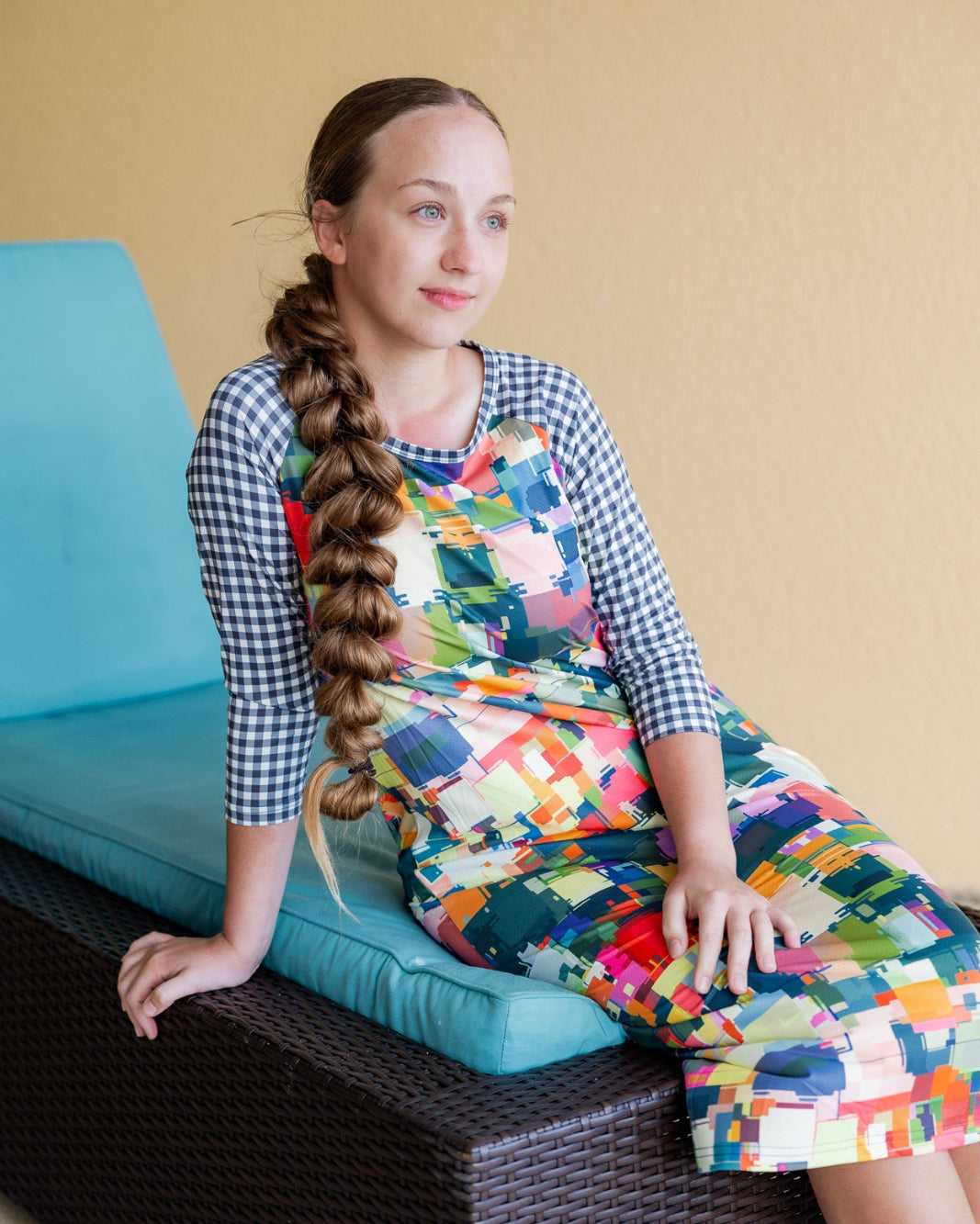 Model wearing Nuggles® Sport Swim Dress in Painted Patchwork