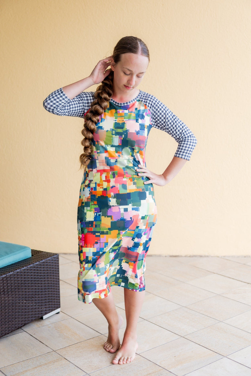 Model wearing Nuggles® Sport Swim Dress in Painted Patchwork