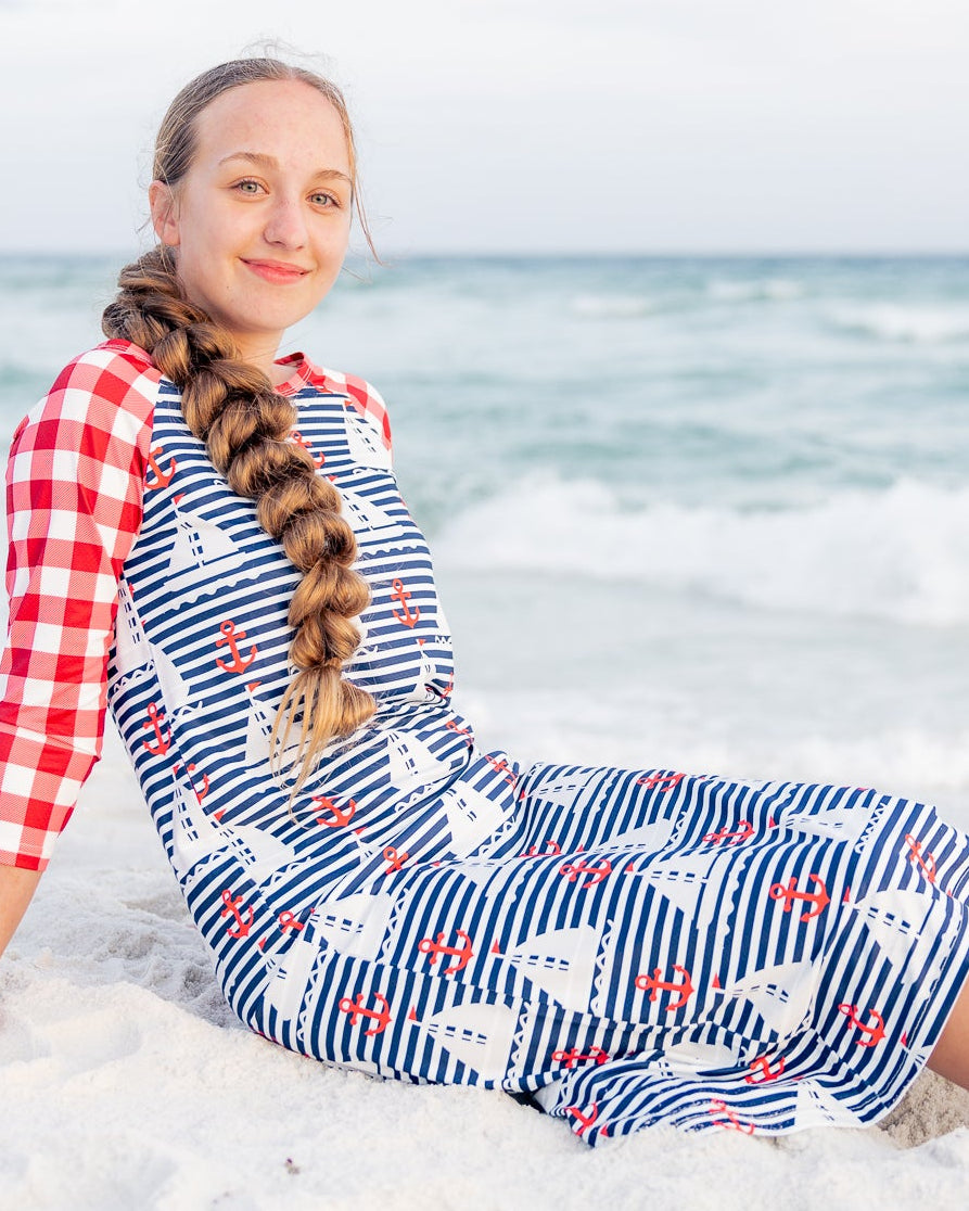 Model wearing Nuggles® Sport Swim Dress in Happy Campers