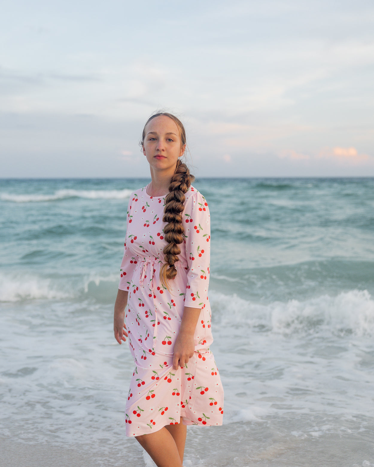 Model wearing Nuggles® Nola Sport Swim Dress in Cherry Soda Shop