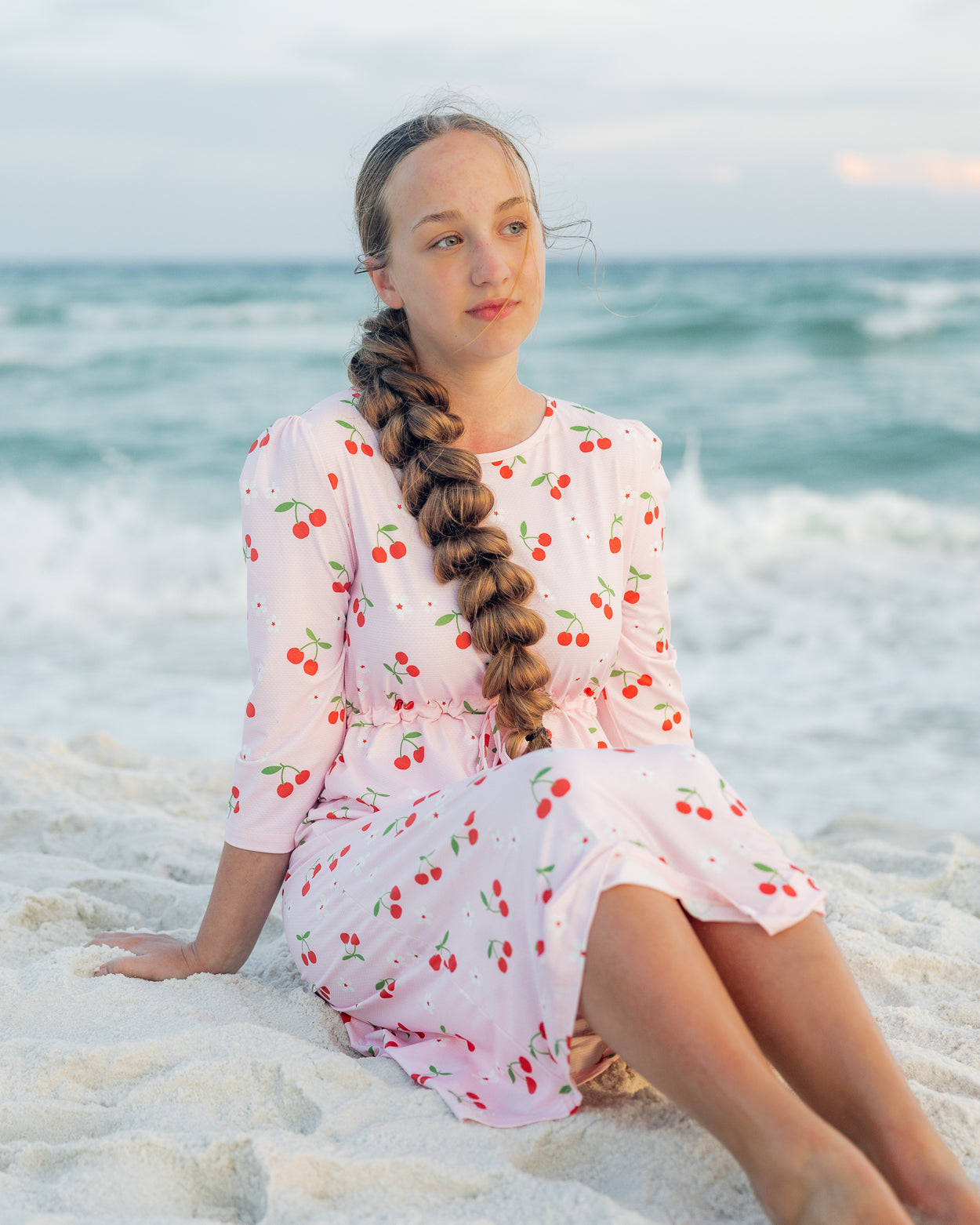 Model wearing Nuggles® Nola Sport Swim Dress in Cherry Soda Shop