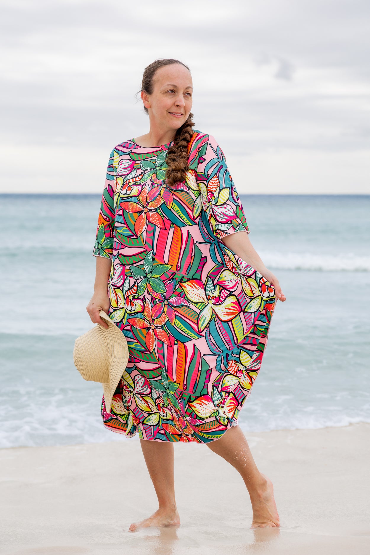 Model wearing Nuggles® Carlie Swim Dress in Aloha Bloom