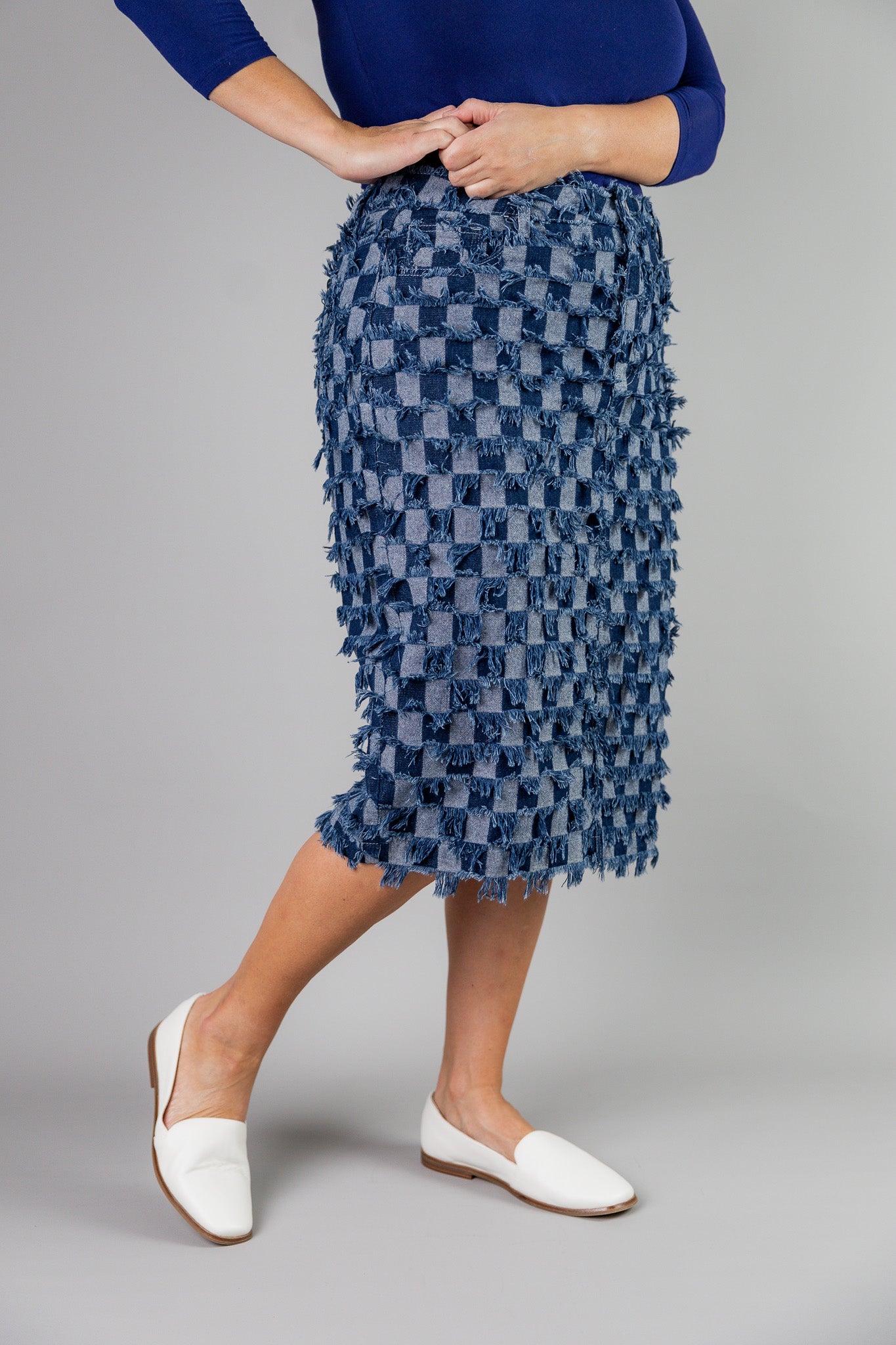 Nuggles® denim midi skirt with soft stretch fabric, wide elastic waistband, modest length, and functional pockets. Available in 27", 31", and 34" lengths.