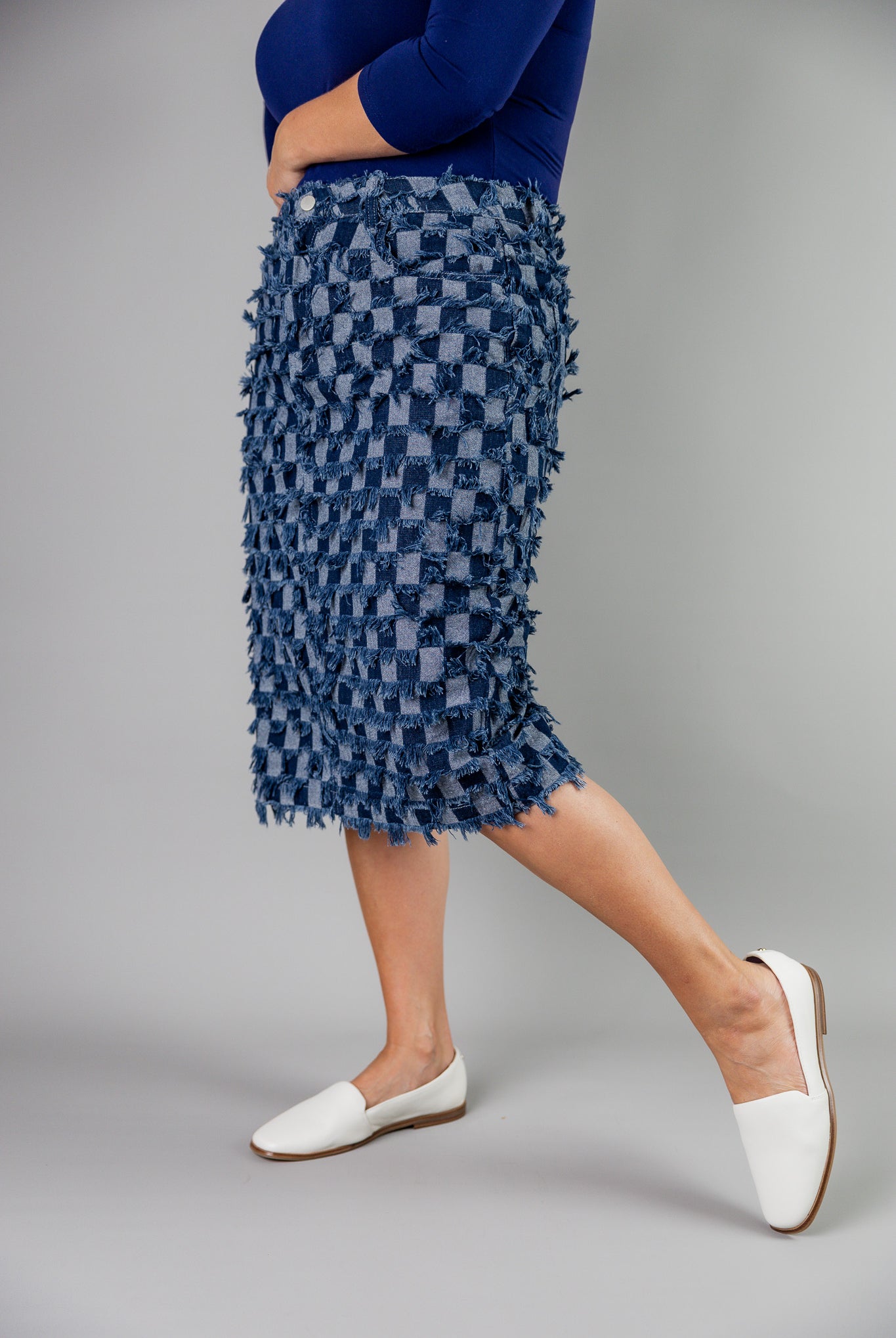 Nuggles® denim midi skirt with soft stretch fabric, wide elastic waistband, modest length, and functional pockets. Available in 27", 31", and 34" lengths.