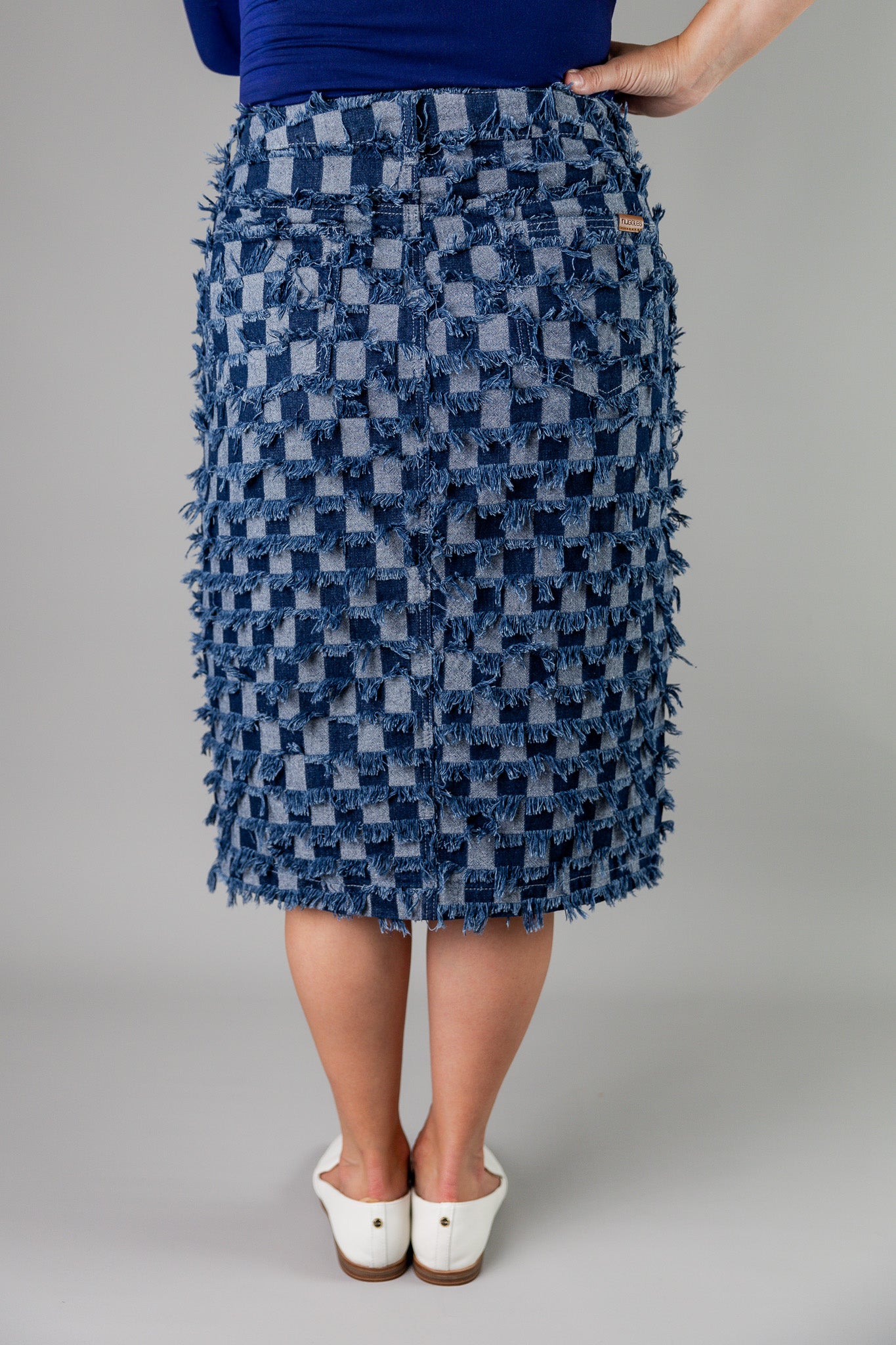 Nuggles® denim midi skirt with soft stretch fabric, wide elastic waistband, modest length, and functional pockets. Available in 27", 31", and 34" lengths.