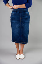 Nuggles® denim midi skirt with soft stretch fabric, wide elastic waistband, modest length, and functional pockets. Available in 27", 31", and 34" lengths.