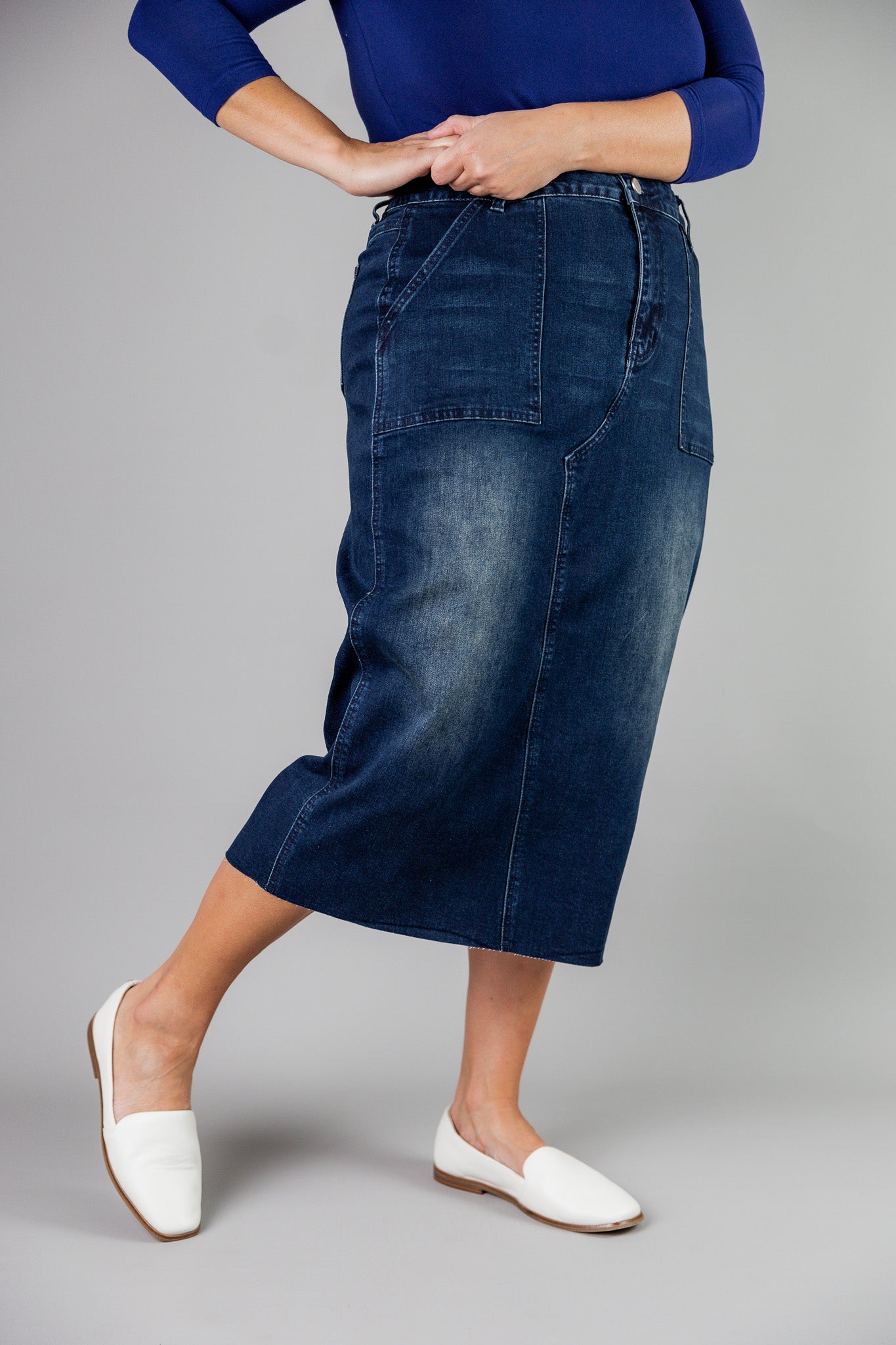 Nuggles® denim midi skirt with soft stretch fabric, wide elastic waistband, modest length, and functional pockets. Available in 27", 31", and 34" lengths.