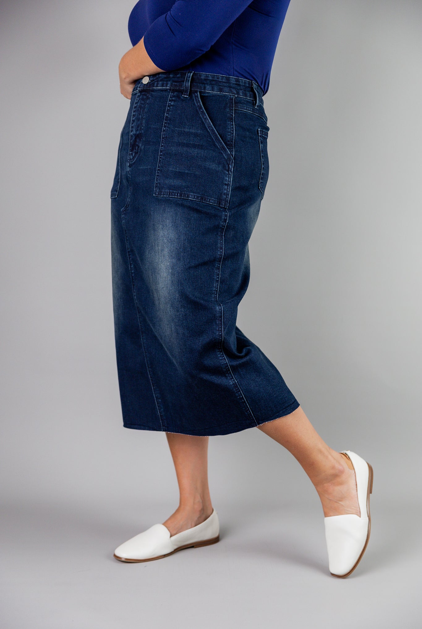 Nuggles® denim midi skirt with soft stretch fabric, wide elastic waistband, modest length, and functional pockets. Available in 27", 31", and 34" lengths.