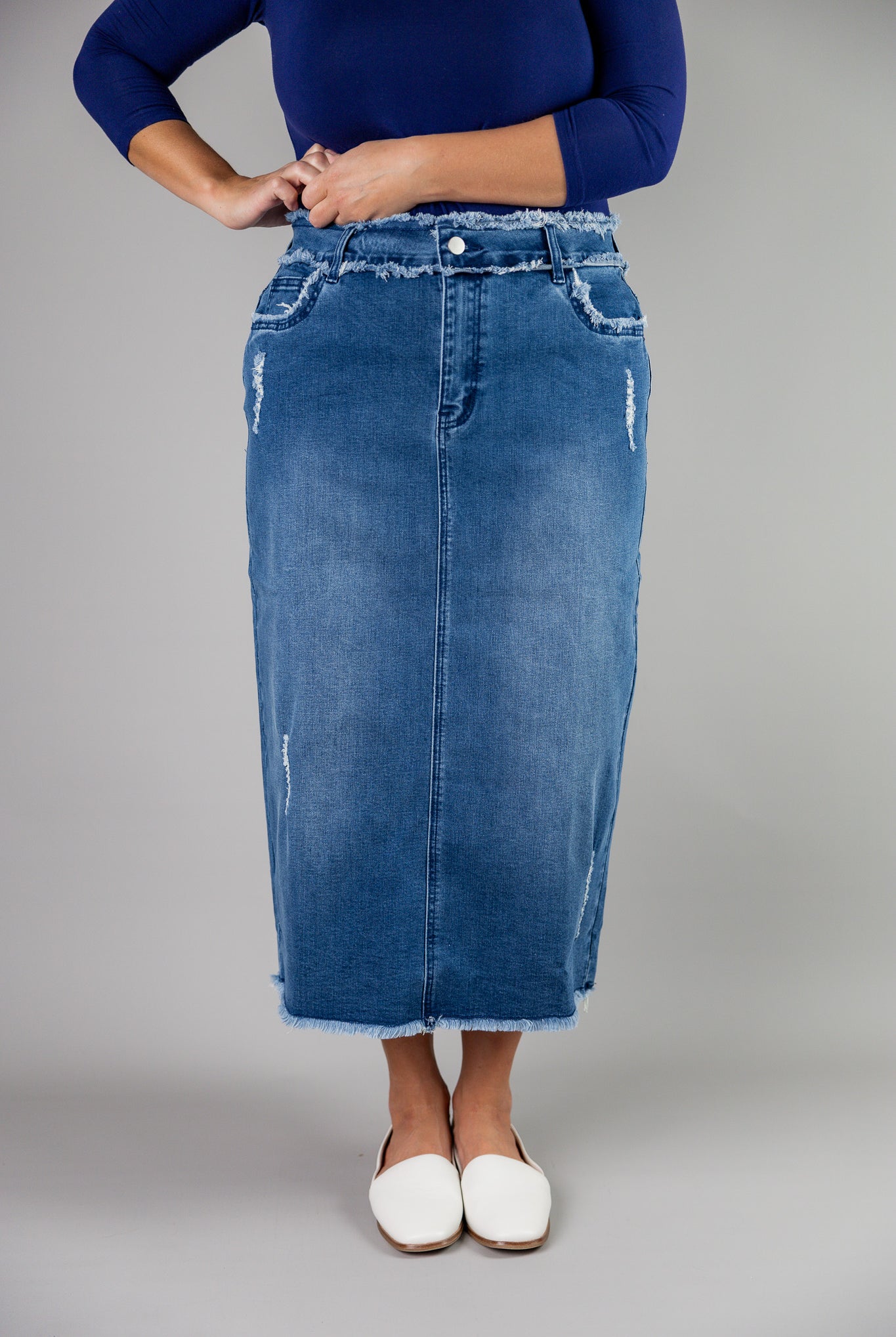 Nuggles® denim midi skirt with soft stretch fabric, wide elastic waistband, modest length, and functional pockets. Available in 27", 31", and 34" lengths.