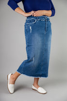 Nuggles® denim midi skirt with soft stretch fabric, wide elastic waistband, modest length, and functional pockets. Available in 27", 31", and 34" lengths.