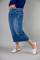 Nuggles® denim midi skirt with soft stretch fabric, wide elastic waistband, modest length, and functional pockets. Available in 27", 31", and 34" lengths.