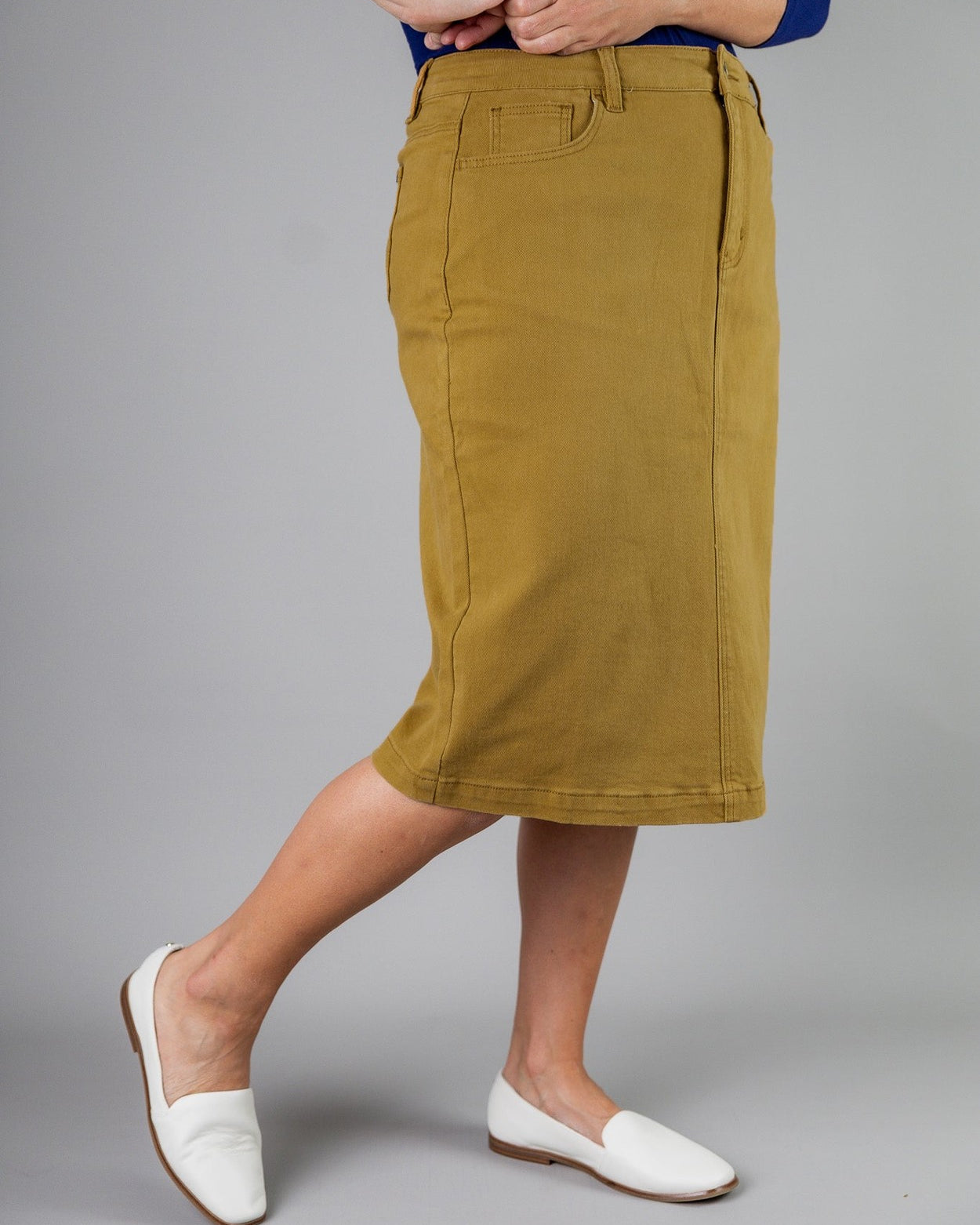 Nuggles® denim midi skirt with soft stretch fabric, wide elastic waistband, modest length, and functional pockets. Available in 27", 31", and 34" lengths.