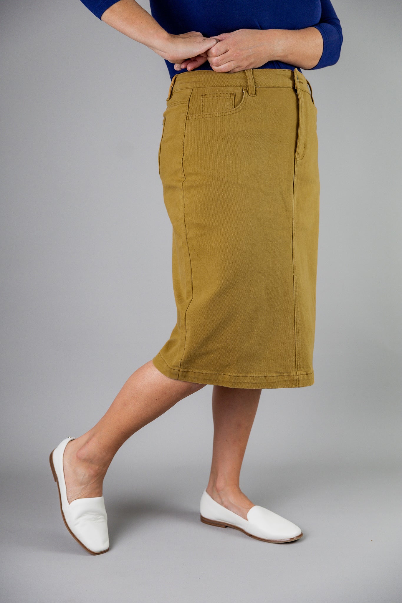 Nuggles® denim midi skirt with soft stretch fabric, wide elastic waistband, modest length, and functional pockets. Available in 27", 31", and 34" lengths.