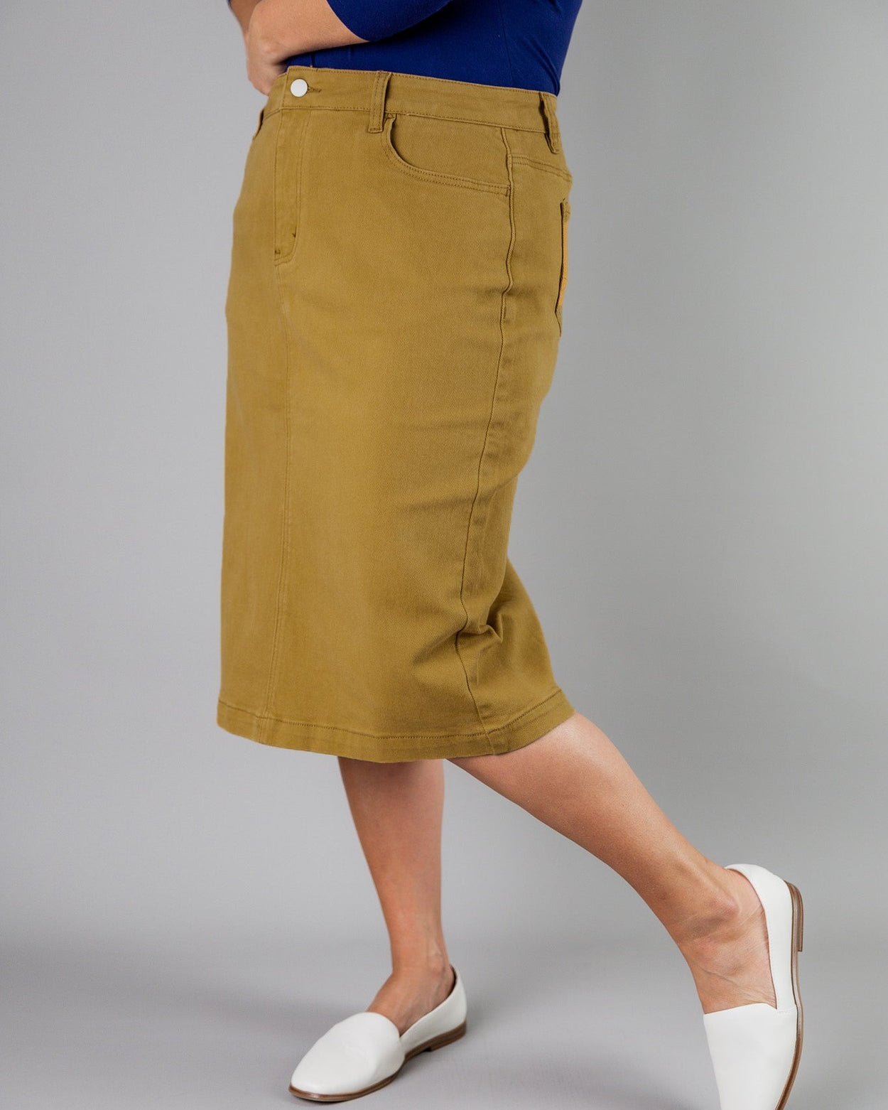Nuggles® denim midi skirt with soft stretch fabric, wide elastic waistband, modest length, and functional pockets. Available in 27", 31", and 34" lengths.