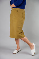 Nuggles® denim midi skirt with soft stretch fabric, wide elastic waistband, modest length, and functional pockets. Available in 27", 31", and 34" lengths.