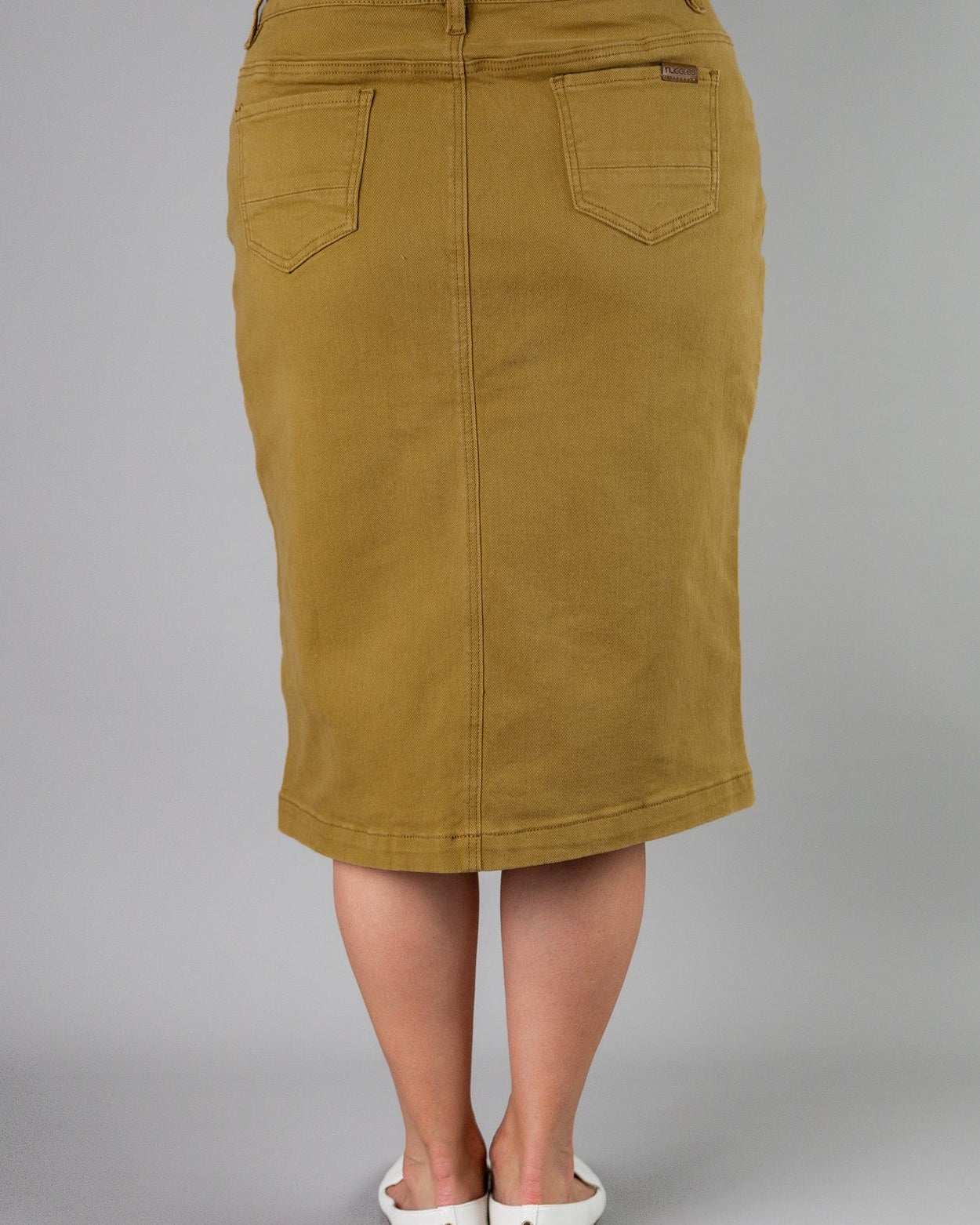 Nuggles® denim midi skirt with soft stretch fabric, wide elastic waistband, modest length, and functional pockets. Available in 27", 31", and 34" lengths.