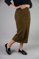 Nuggles® denim midi skirt with soft stretch fabric, wide elastic waistband, modest length, and functional pockets. Available in 27", 31", and 34" lengths.