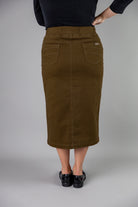 Nuggles® denim midi skirt with soft stretch fabric, wide elastic waistband, modest length, and functional pockets. Available in 27", 31", and 34" lengths.