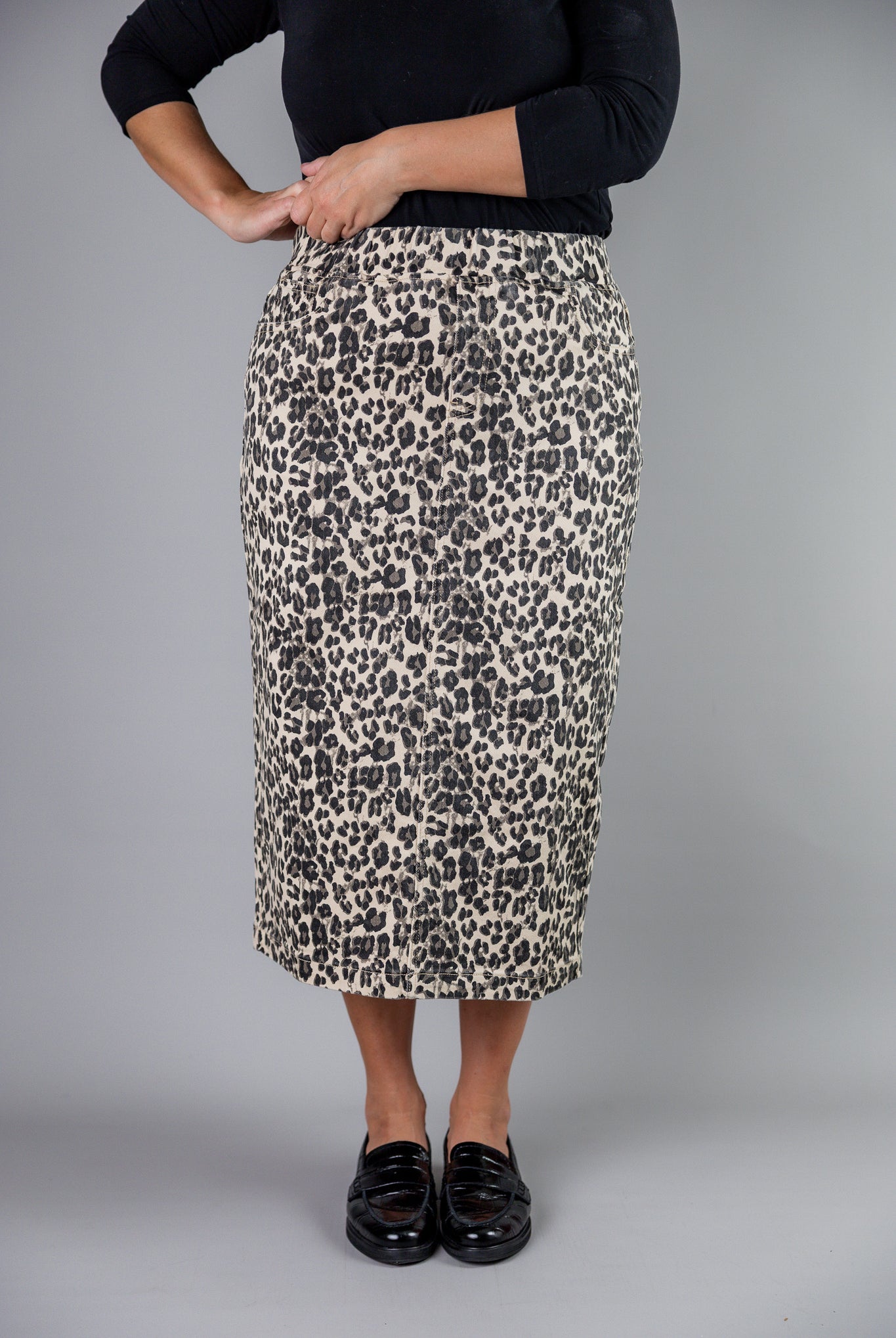 Nuggles® denim midi skirt with soft stretch fabric, wide elastic waistband, modest length, and functional pockets. Available in 27", 31", and 34" lengths.