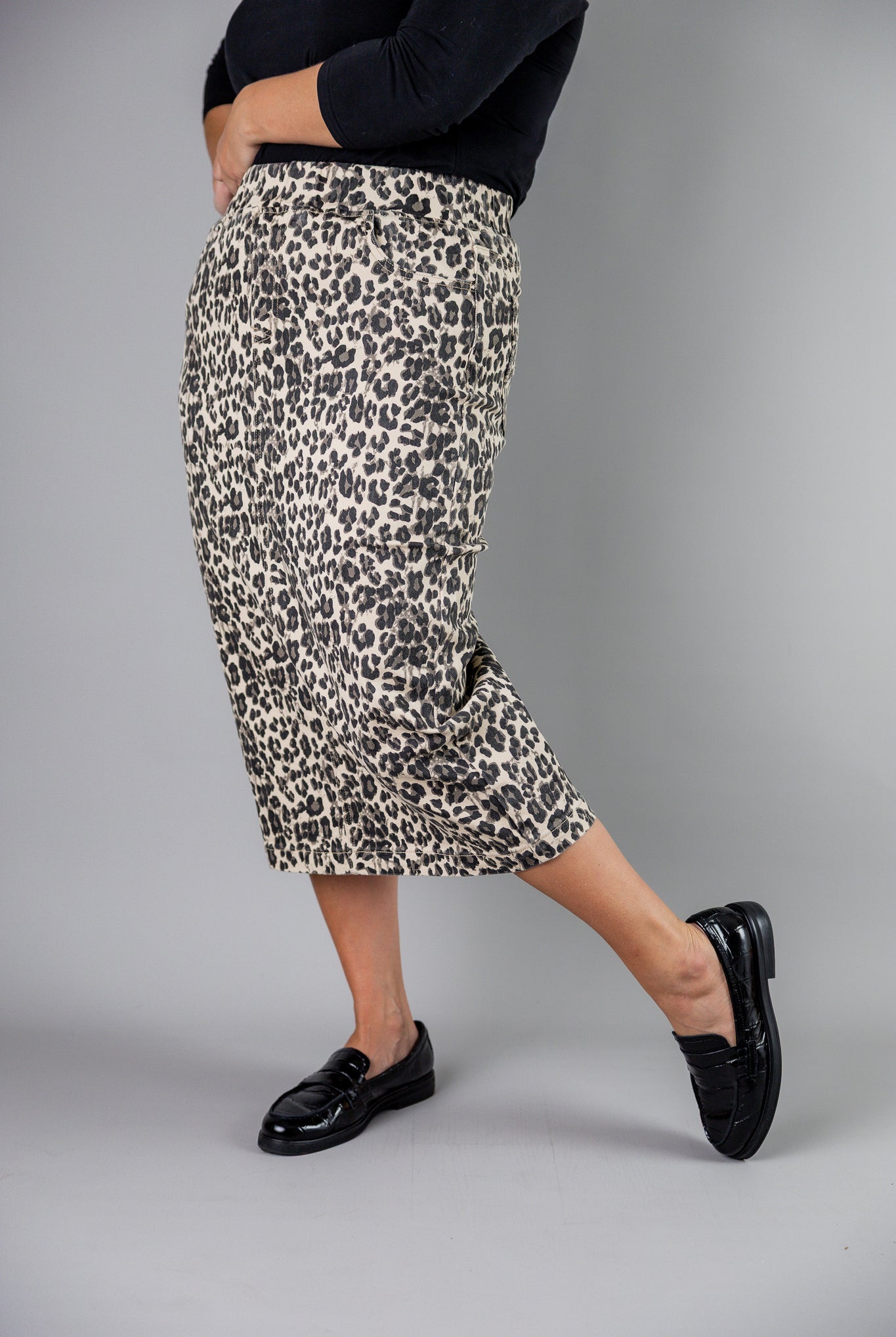 Nuggles® denim midi skirt with soft stretch fabric, wide elastic waistband, modest length, and functional pockets. Available in 27", 31", and 34" lengths.