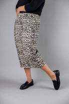 Nuggles® denim midi skirt with soft stretch fabric, wide elastic waistband, modest length, and functional pockets. Available in 27", 31", and 34" lengths.