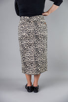 Nuggles® denim midi skirt with soft stretch fabric, wide elastic waistband, modest length, and functional pockets. Available in 27", 31", and 34" lengths.