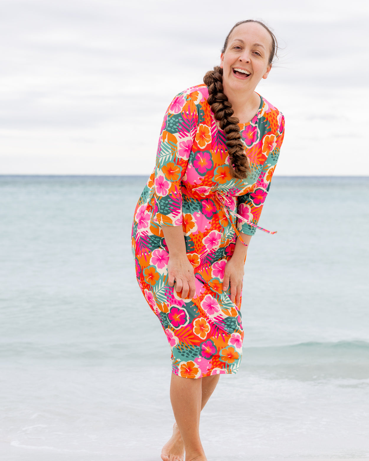 Model wearing Nuggles® Nola Sport Swim Dress in Luau Garden