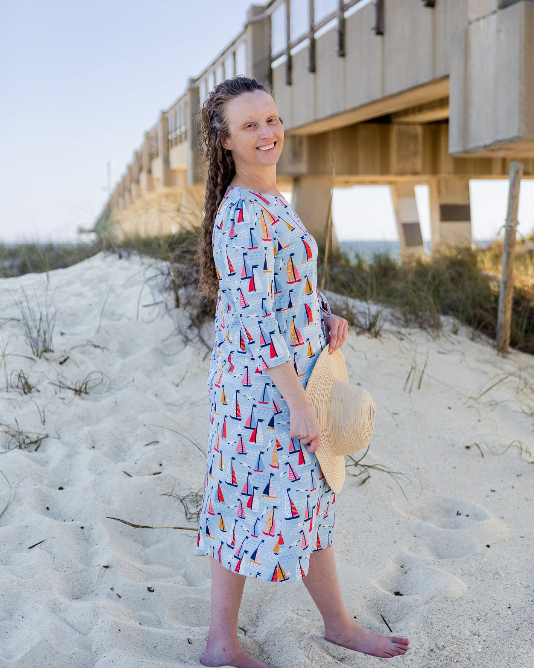 Model wearing Nuggles® Nola Sport Swim Dress in Harbor Sailboats