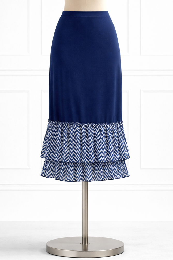 A mannequin wearing a navy blue knit slip with a blue and white chevron fabric ruffle.