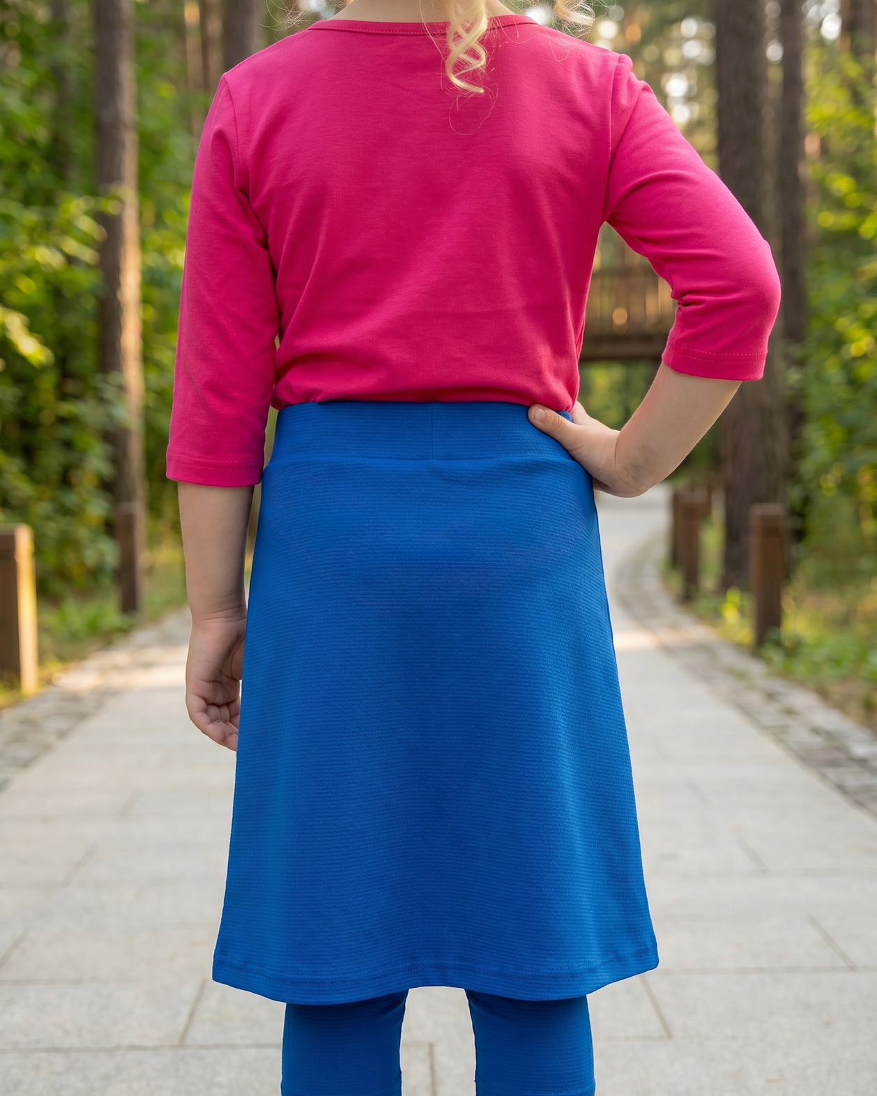 Model wearing Nuggles® Girls All-Sport Skirt in Lapiz Blue