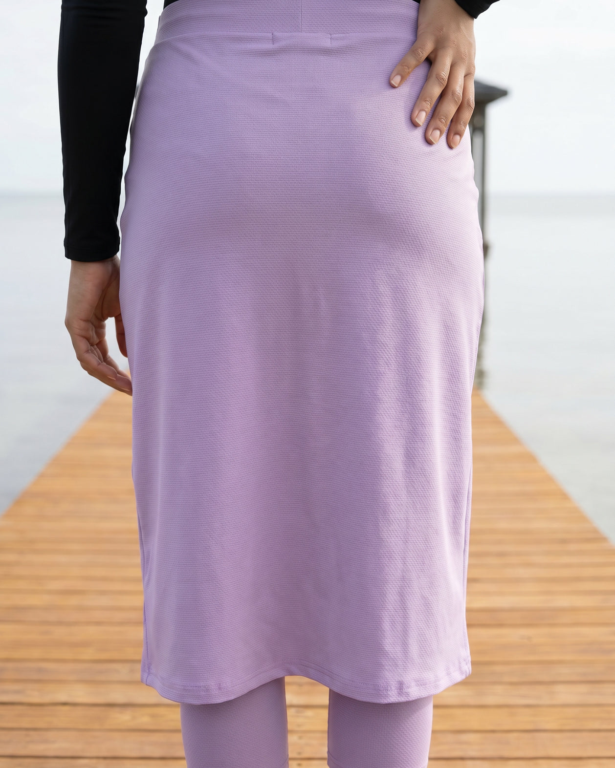 Model wearing Nuggles® 27"All-Sport Skirt in Lavender