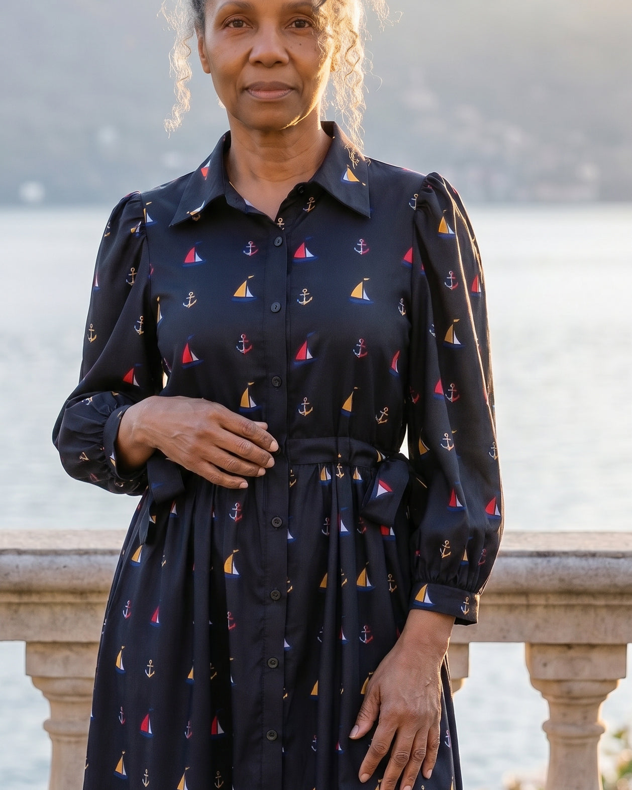 A picture of an older women wearing a blue button down dress.