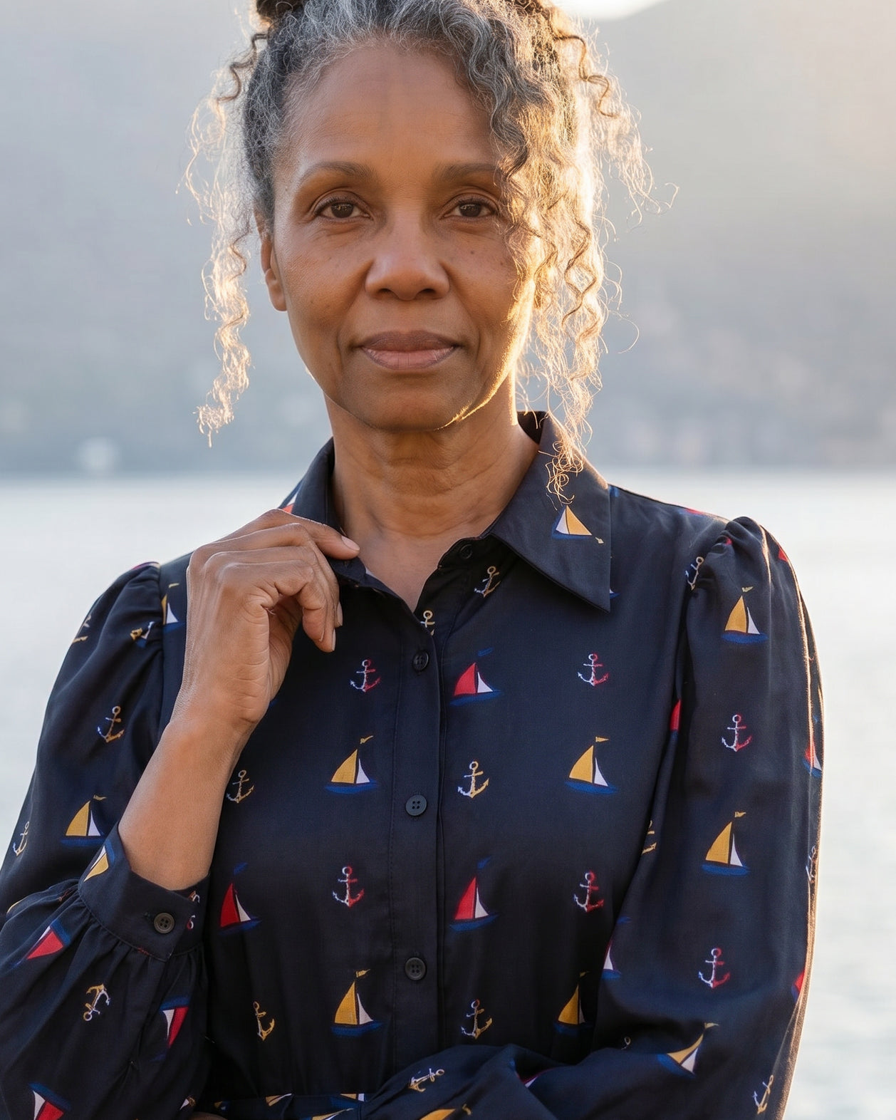 A picture of an older women wearing a blue button down dress.