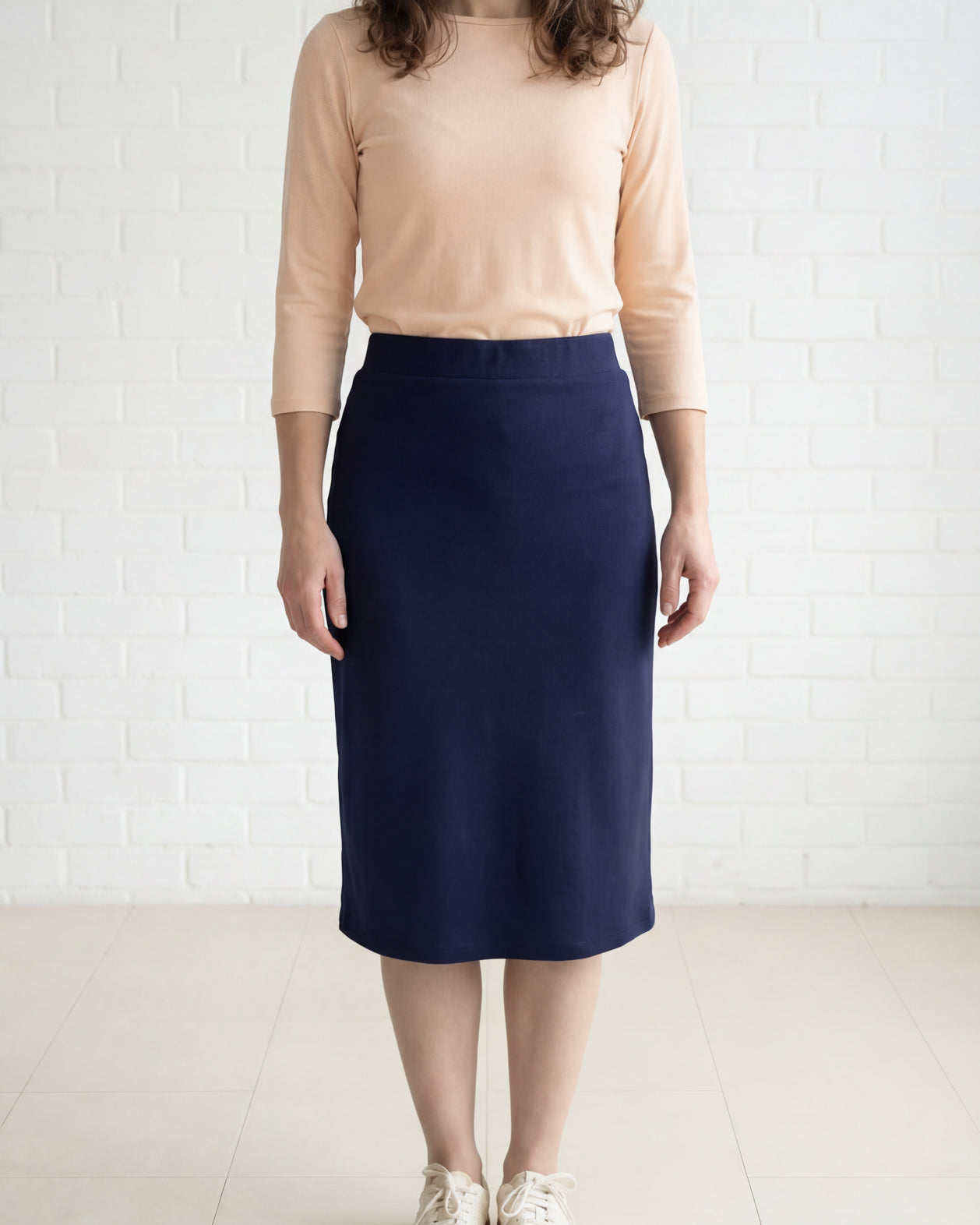Model wearing Nuggles® 27" Relaxed Midi Skirt in Navy