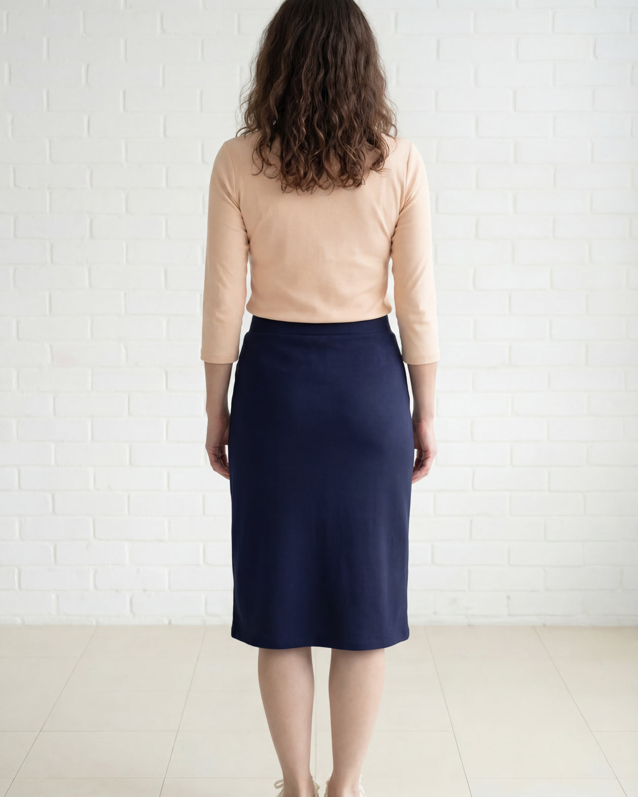 Model wearing Nuggles® 27" Relaxed Midi Skirt in Navy