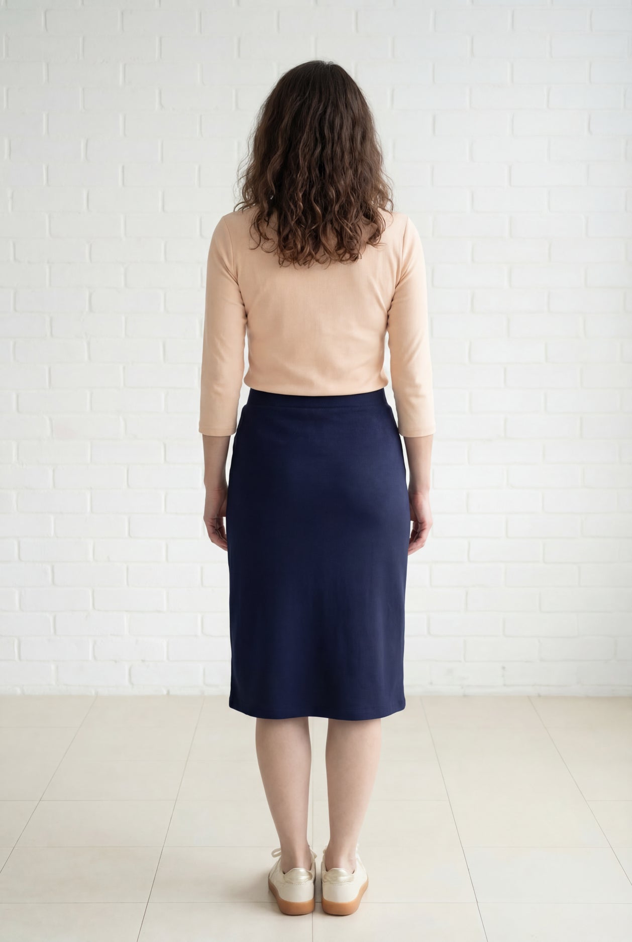 Model wearing Nuggles® 27" Relaxed Midi Skirt in Navy