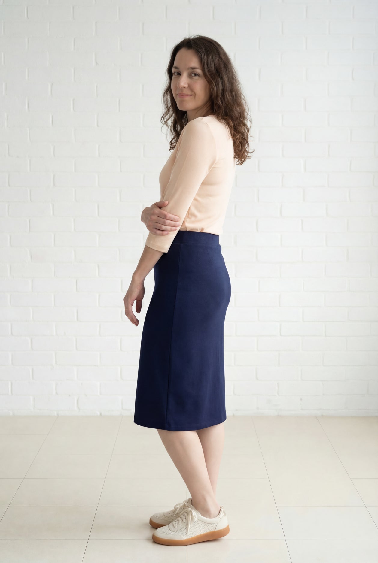 Model wearing Nuggles® 27" Relaxed Midi Skirt in Navy