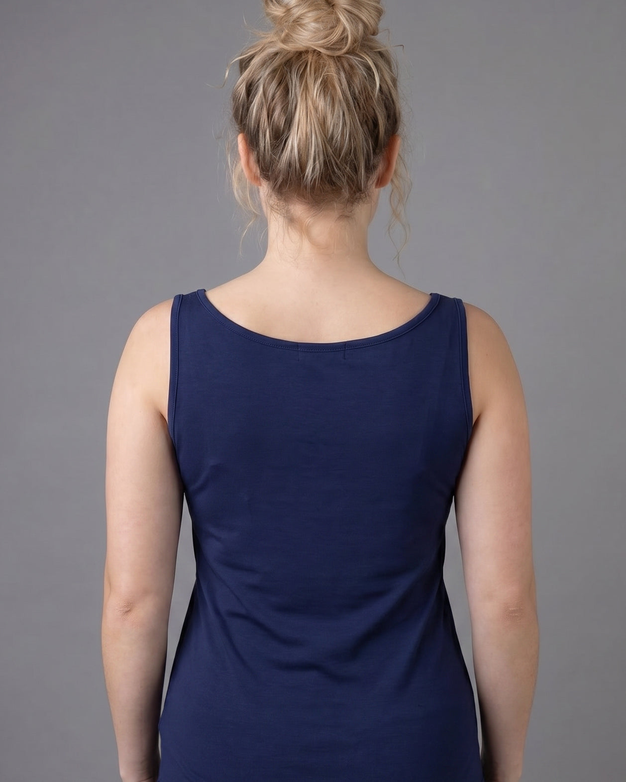 Model wearing Nuggles® Wide Neck Tank in Navy