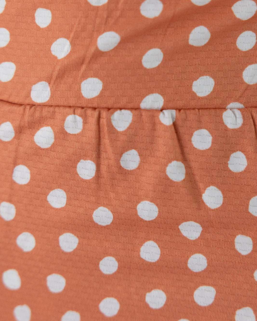 Model wearing Nuggles® 27" All-Sport Skirt in Orange Pop