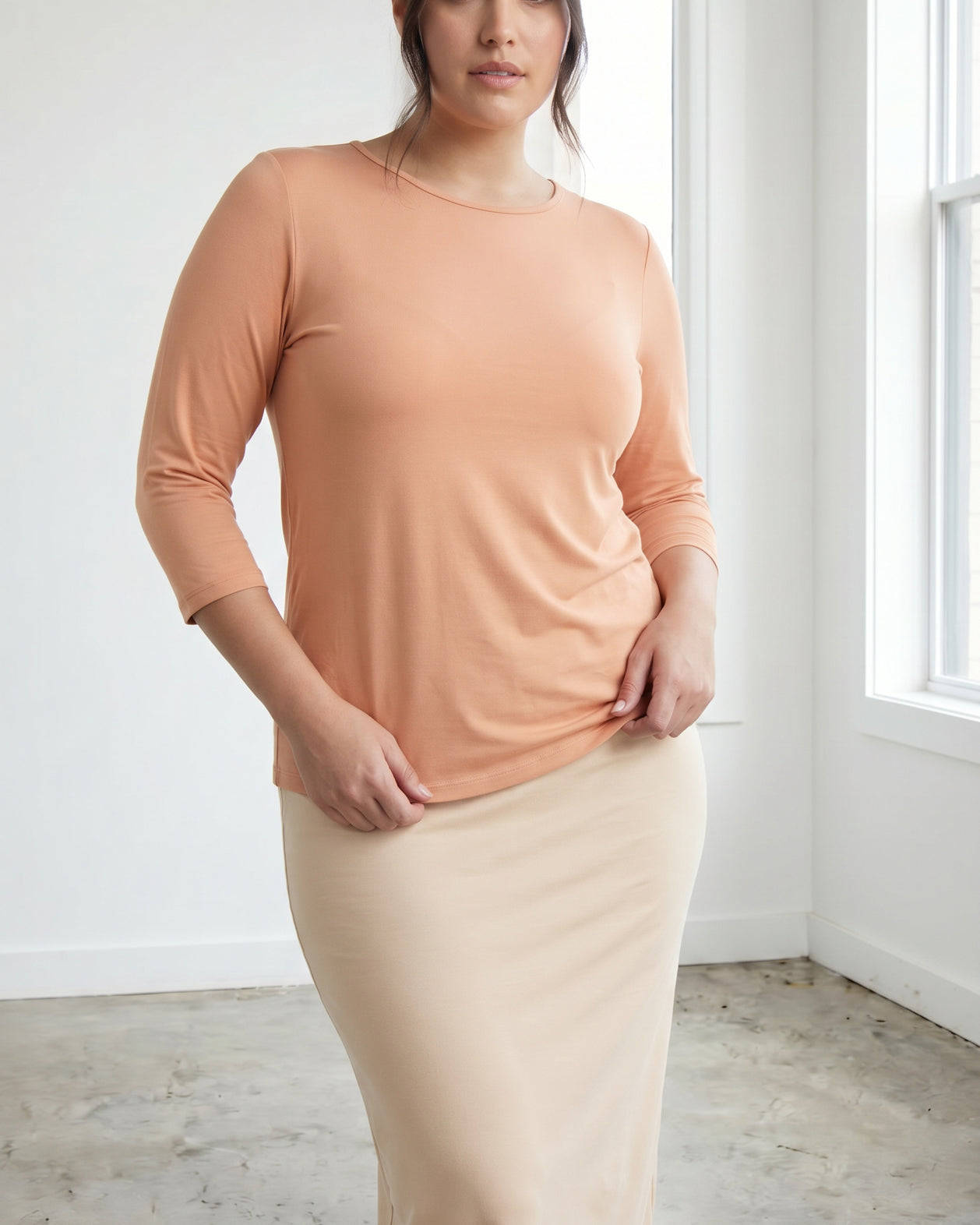 Model wearing Nuggles® 3/4 Essential Tee in Peach