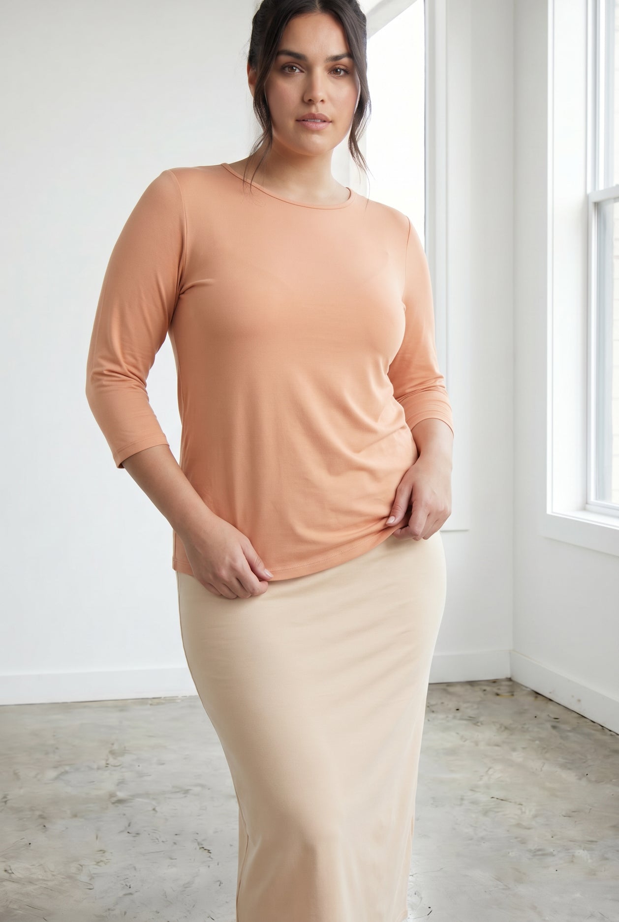 Model wearing Nuggles® 3/4 Essential Tee in Peach