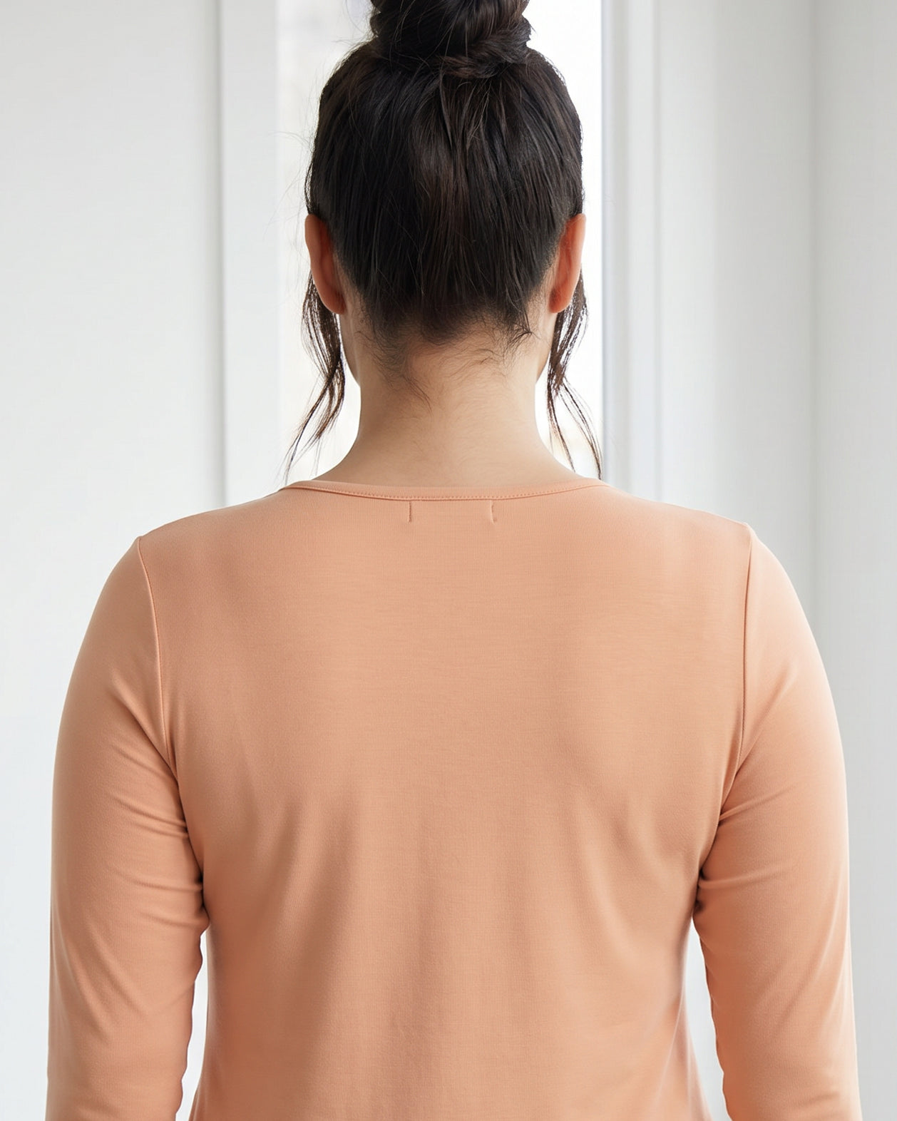 Model wearing Nuggles® 3/4 Essential Tee in Peach