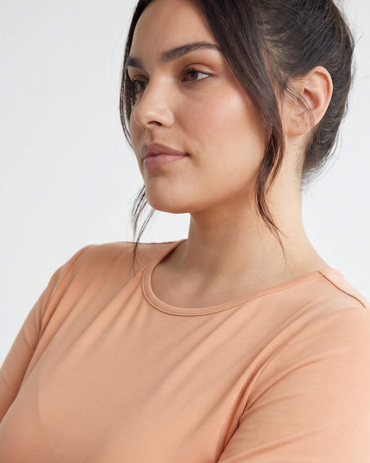 Model wearing Nuggles® 3/4 Essential Tee in Peach
