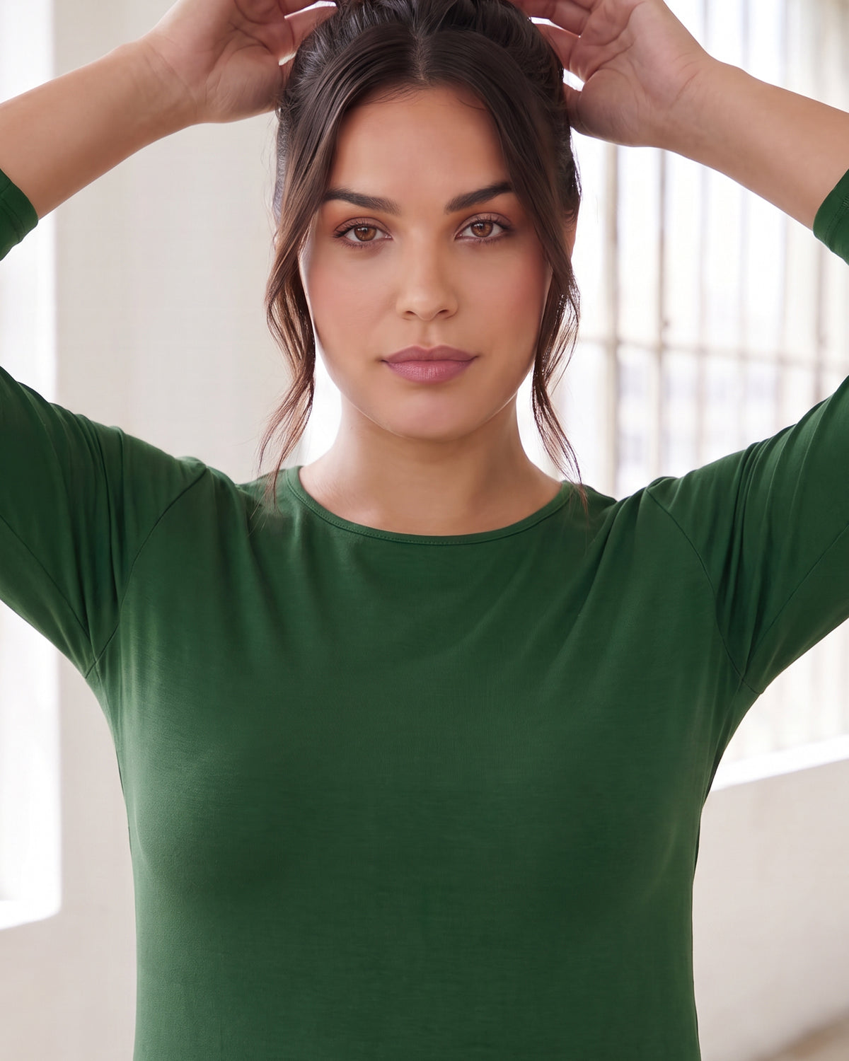Model wearing Nuggles® Essential 3/4 Tee in Pine Green