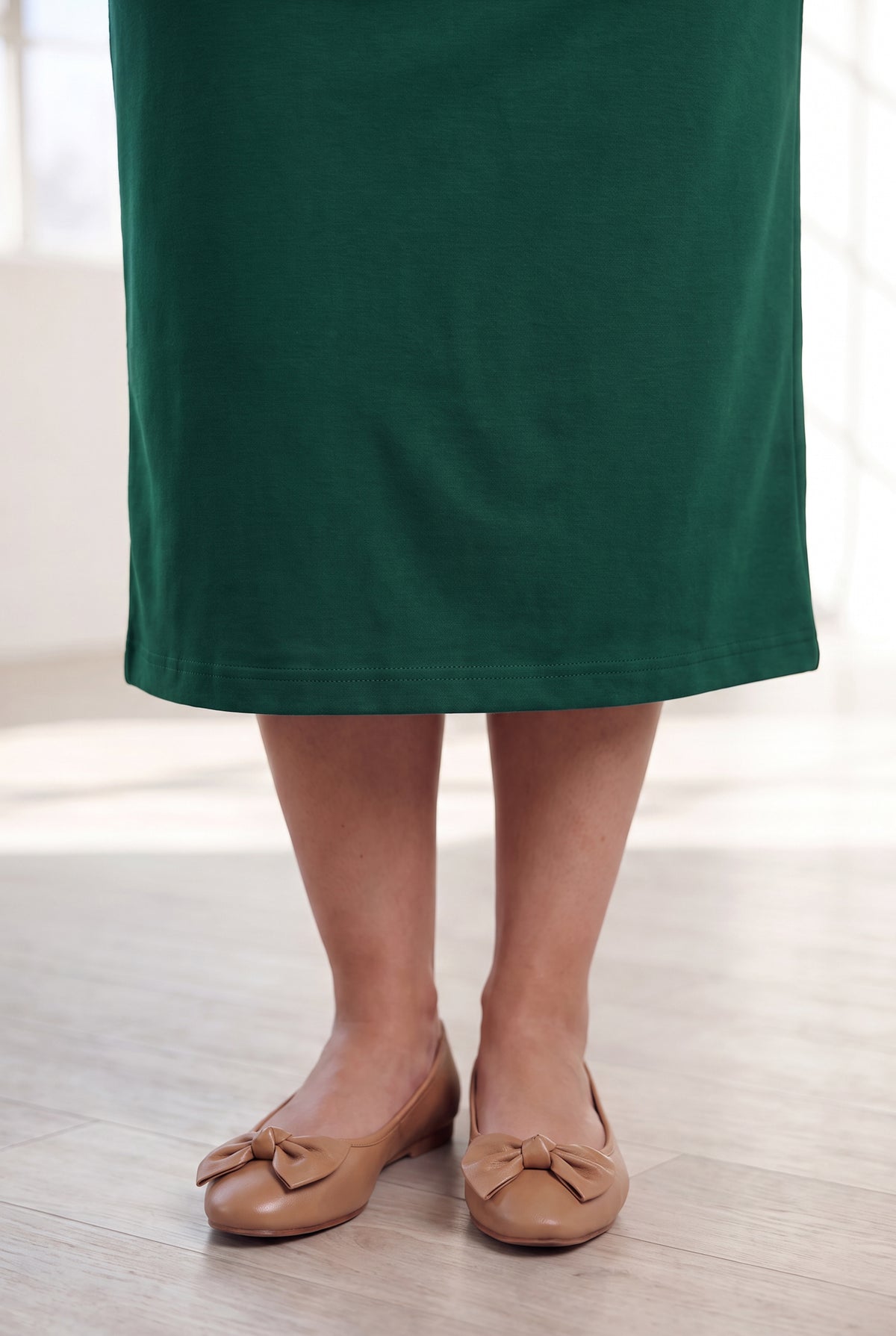 Model wearing Nuggles® 31" Classic Skirt in Pine Green