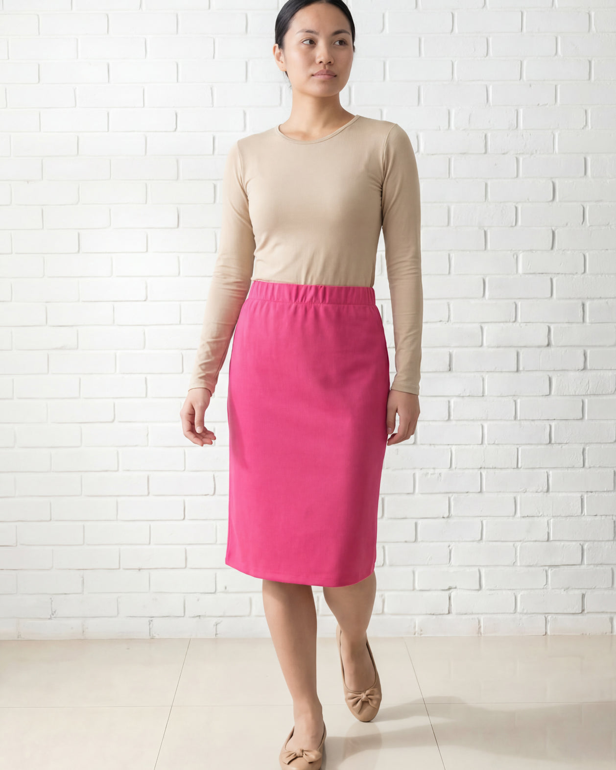 Model wearing Nuggles® 25" Relaxed Midi Skirt in Pink