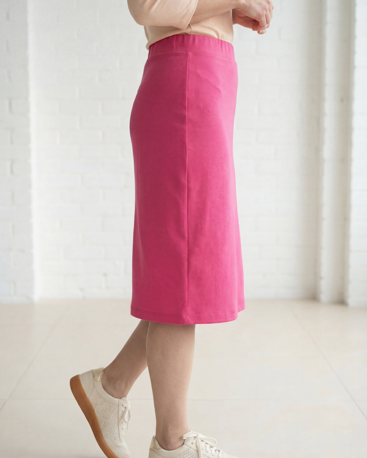 Model wearing Nuggles® 27" Relaxed Midi Skirt in Pink