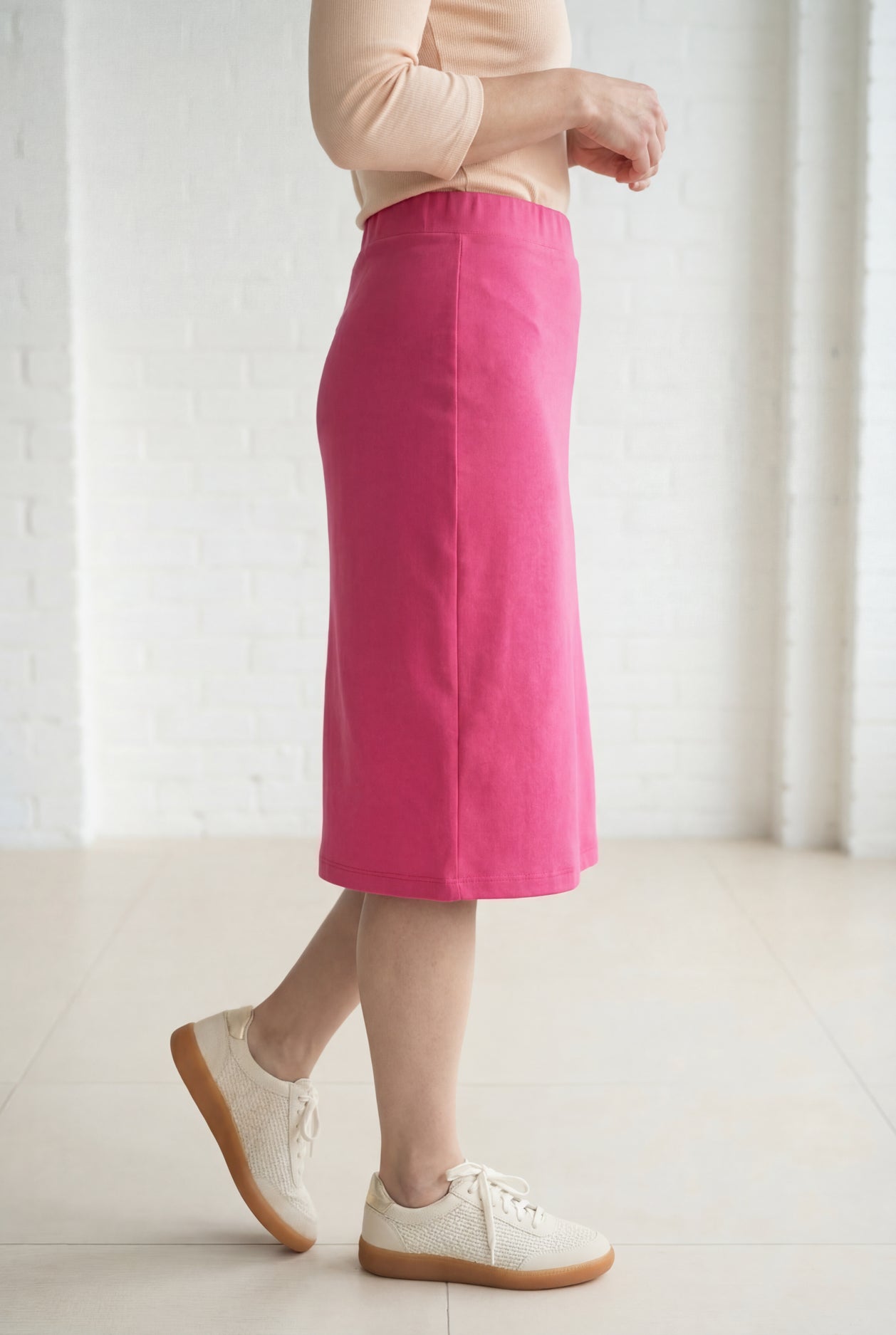 Model wearing Nuggles® 27" Relaxed Midi Skirt in Pink
